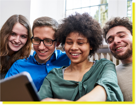 Diverse group of young people smiling at a tablet